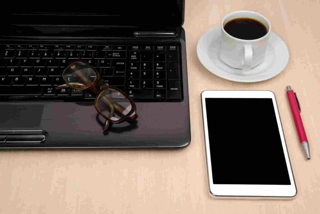 Tablet vs Laptop for ADHD Productivity on a tidy UK desk with tablet, laptop, notebook, and tea"